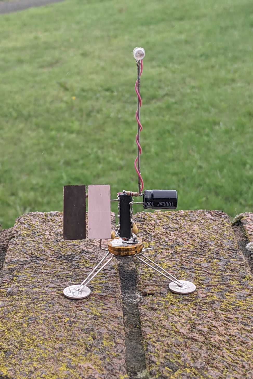 Satellite-like robot with flashing LED.